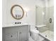 Elegant bathroom featuring a marble countertop, wood-framed mirror, and glass-enclosed shower with bench at 3930 Peachtree Dunwoody Ne Rd, Atlanta, GA 30342