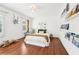 Cozy bedroom featuring hardwood floors, a plush bed, and built-in bookshelves at 3930 Peachtree Dunwoody Ne Rd, Atlanta, GA 30342