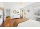 Bright bedroom with hardwood floors, white walls, and a cozy sitting area at 3930 Peachtree Dunwoody Ne Rd, Atlanta, GA 30342