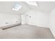 Bright bedroom featuring neutral carpet, a raised platform, and two skylights for ample natural light at 3930 Peachtree Dunwoody Ne Rd, Atlanta, GA 30342