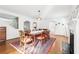 Elegant dining room with hardwood floors, fireplace, and open layout to other rooms at 3930 Peachtree Dunwoody Ne Rd, Atlanta, GA 30342