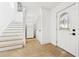 Inviting entryway boasts travertine floors, stairway, coat closet and a door with decorative glass at 3930 Peachtree Dunwoody Ne Rd, Atlanta, GA 30342