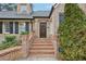 Elegant brick entryway featuring a wooden front door and manicured landscaping at 3930 Peachtree Dunwoody Ne Rd, Atlanta, GA 30342