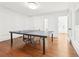 Spacious game room featuring hardwood floors and a ping pong table at 3930 Peachtree Dunwoody Ne Rd, Atlanta, GA 30342