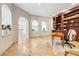 Charming home office boasts travertine floors, white brick arches, and built-in bookshelves at 3930 Peachtree Dunwoody Ne Rd, Atlanta, GA 30342