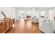 Bright living room with hardwood floors, neutral tones, and arched doorways to dining area at 3930 Peachtree Dunwoody Ne Rd, Atlanta, GA 30342
