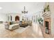 Spacious living room featuring a brick fireplace, travertine floors, and ample natural light at 3930 Peachtree Dunwoody Ne Rd, Atlanta, GA 30342