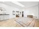 Sunlit living room showcasing tile floors, a skylight, and a view to other living spaces at 3930 Peachtree Dunwoody Ne Rd, Atlanta, GA 30342