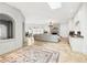 Open-concept living room featuring travertine floors, white brick accents, fireplace, and bar area at 3930 Peachtree Dunwoody Ne Rd, Atlanta, GA 30342