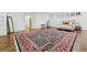 Large bedroom with hardwood floors featuring a decorative rug and a sitting area at 3930 Peachtree Dunwoody Ne Rd, Atlanta, GA 30342