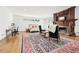 Spacious bedroom boasting a fireplace, sitting area, hardwood floors, and natural light at 3930 Peachtree Dunwoody Ne Rd, Atlanta, GA 30342