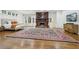 Primary bedroom featuring hardwood floors, fireplace, sitting area, and natural lighting at 3930 Peachtree Dunwoody Ne Rd, Atlanta, GA 30342