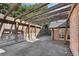 Charming patio with a wooden pergola, stone accents, and a glimpse of the surrounding landscape at 3930 Peachtree Dunwoody Ne Rd, Atlanta, GA 30342