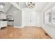 Room featuring tile floors, a white door, modern lighting, and an open view to the kitchen at 3930 Peachtree Dunwoody Ne Rd, Atlanta, GA 30342