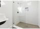 Modern shower with white subway tile, mosaic tile flooring and a glass door at 3930 Peachtree Dunwoody Ne Rd, Atlanta, GA 30342