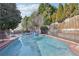 Relaxing backyard swimming pool with brick pavers and a secure fence, perfect for Gathering fun at 3930 Peachtree Dunwoody Ne Rd, Atlanta, GA 30342