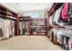 Spacious walk-in closet with custom shelving and plenty of storage for clothes and shoes at 3930 Peachtree Dunwoody Ne Rd, Atlanta, GA 30342