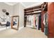 Walk-in closet with built-in shelving and a full-length mirror at 3930 Peachtree Dunwoody Ne Rd, Atlanta, GA 30342