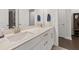 Elegant bathroom with double sinks, a white marble countertop, and modern fixtures at 3695 Townley Ln, Cumming, GA 30040