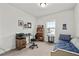 Cozy bedroom with neutral walls, a single bed, a small desk, and a window overlooking the neighborhood at 3695 Townley Ln, Cumming, GA 30040