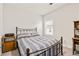 Comfortable bedroom featuring a metal frame bed and classic furniture at 3695 Townley Ln, Cumming, GA 30040