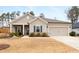 Charming single-story home with a well-maintained lawn and attached garage in a suburban neighborhood at 3695 Townley Ln, Cumming, GA 30040