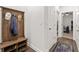Inviting hallway with a rustic coat rack and hardwood floors and blue rug at 3695 Townley Ln, Cumming, GA 30040