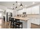 Bright kitchen boasts a large granite island, stainless steel appliances, and modern white cabinetry at 3695 Townley Ln, Cumming, GA 30040
