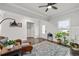 Bright living room with hardwood flooring, featuring elegant furniture, a patterned rug, and ample natural light at 3695 Townley Ln, Cumming, GA 30040