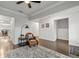 Well-lit living space featuring hardwood floors, a patterned rug, and a comfortable seating area with stylish decor at 3695 Townley Ln, Cumming, GA 30040
