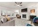 Spacious living room with a cozy fireplace, large sectional sofa, and natural light at 3695 Townley Ln, Cumming, GA 30040