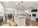 Open concept living space with a kitchen island, adjacent dining area, and a comfortable living room at 3695 Townley Ln, Cumming, GA 30040