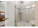 Modern bathroom with tiled glass shower, bench, and an adjoining main bedroom at 3695 Townley Ln, Cumming, GA 30040