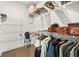 Organized walk-in closet with multiple shelves, hanging racks, and wood flooring at 3695 Townley Ln, Cumming, GA 30040