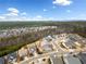 Beautiful aerial view of a residential neighborhood with winding streets, mature trees, and mountain views in the background at 117 Laurel Vw, Canton, GA 30114