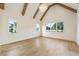 Bright living room with vaulted ceiling, exposed wood beams, and hardwood floors at 200 Heatherton Way, Milton, GA 30009