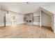 Bright living room with a modern fireplace, floating shelves, hardwood floors and view to the second floor landing at 200 Heatherton Way, Milton, GA 30009