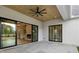 Covered patio with stone flooring, exposed brick, and large sliding doors leading to the indoor living space at 200 Heatherton Way, Milton, GA 30009