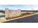 Community entrance with an Echo Glen sign and colorful landscaping along a nicely paved street at 309 Sound Cir, Stockbridge, GA 30281