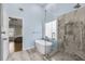 Bright bathroom featuring a soaking tub, tiled shower, and modern finishes at 5450 Taylor Rd, Johns Creek, GA 30022