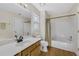 Bathroom featuring a wood vanity with tub and shower combo and neutral paint at 5450 Taylor Rd, Johns Creek, GA 30022