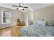 Cozy bedroom with hardwood floors, a ceiling fan, and a window with natural light at 5450 Taylor Rd, Johns Creek, GA 30022