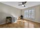 Bright bedroom with hardwood floors, a ceiling fan, a grey filing cabinet, and natural light from the window at 5450 Taylor Rd, Johns Creek, GA 30022