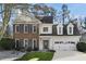 Well-kept home with brick and siding exterior, a front lawn and a driveway at 5450 Taylor Rd, Johns Creek, GA 30022