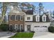 Charming two-story home with a well-manicured lawn and a two-car garage at 5450 Taylor Rd, Johns Creek, GA 30022