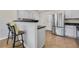 Modern kitchen featuring a breakfast bar with granite countertops and stainless steel appliances at 5450 Taylor Rd, Johns Creek, GA 30022