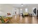 Well-lit living room boasts hardwood floors, comfortable seating, and large windows at 5450 Taylor Rd, Johns Creek, GA 30022
