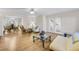 Open-concept living room with hardwood floors seamlessly connects to the dining area and foyer at 5450 Taylor Rd, Johns Creek, GA 30022