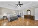 Large main bedroom features hardwood floors, a tray ceiling, and lots of natural light at 5450 Taylor Rd, Johns Creek, GA 30022