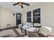 Cozy porch with brick floor, ceiling fan, seating, and front door at 5450 Taylor Rd, Johns Creek, GA 30022